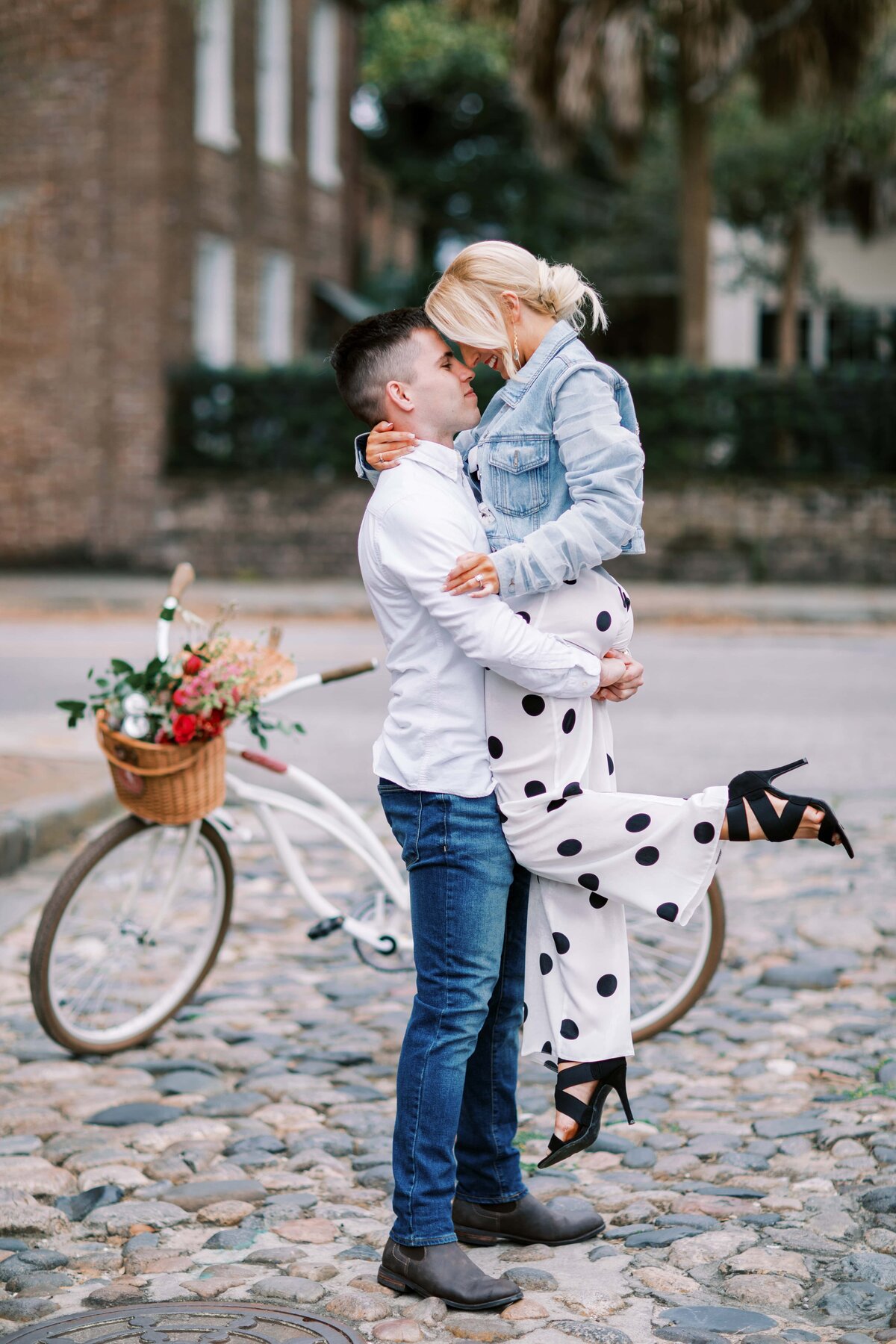 Iconic Charleston engagement photo by Danielle Defayette Photography of cute young couple on cobblestone street on Rainbow Row