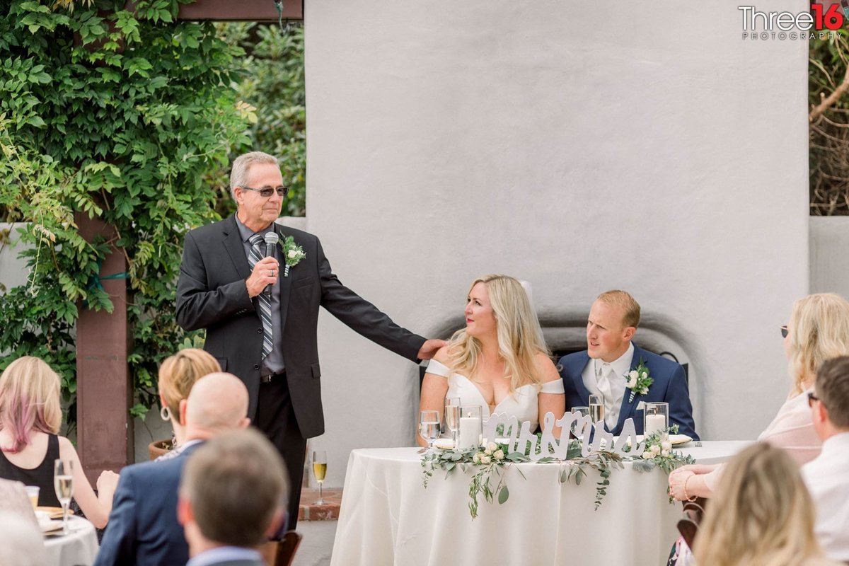 Father of the Brides says a toast