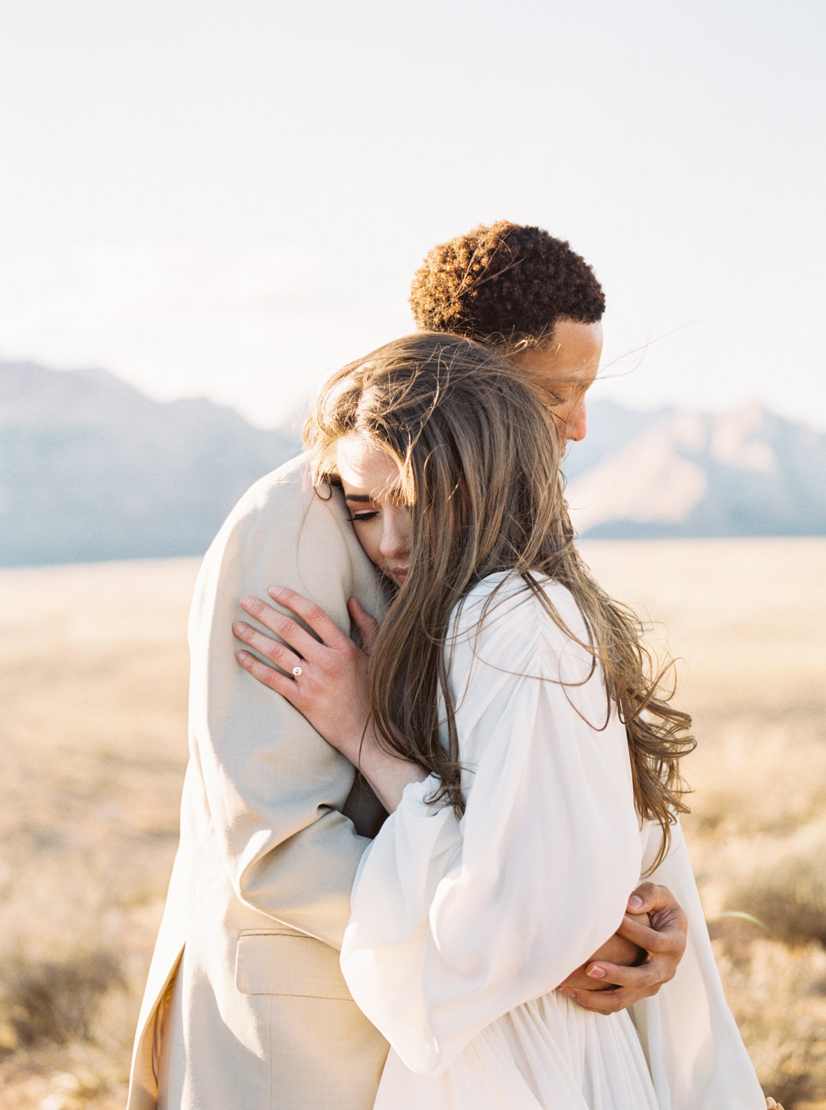 Couple embrace in the cold Las Vegas Desert for a photo session