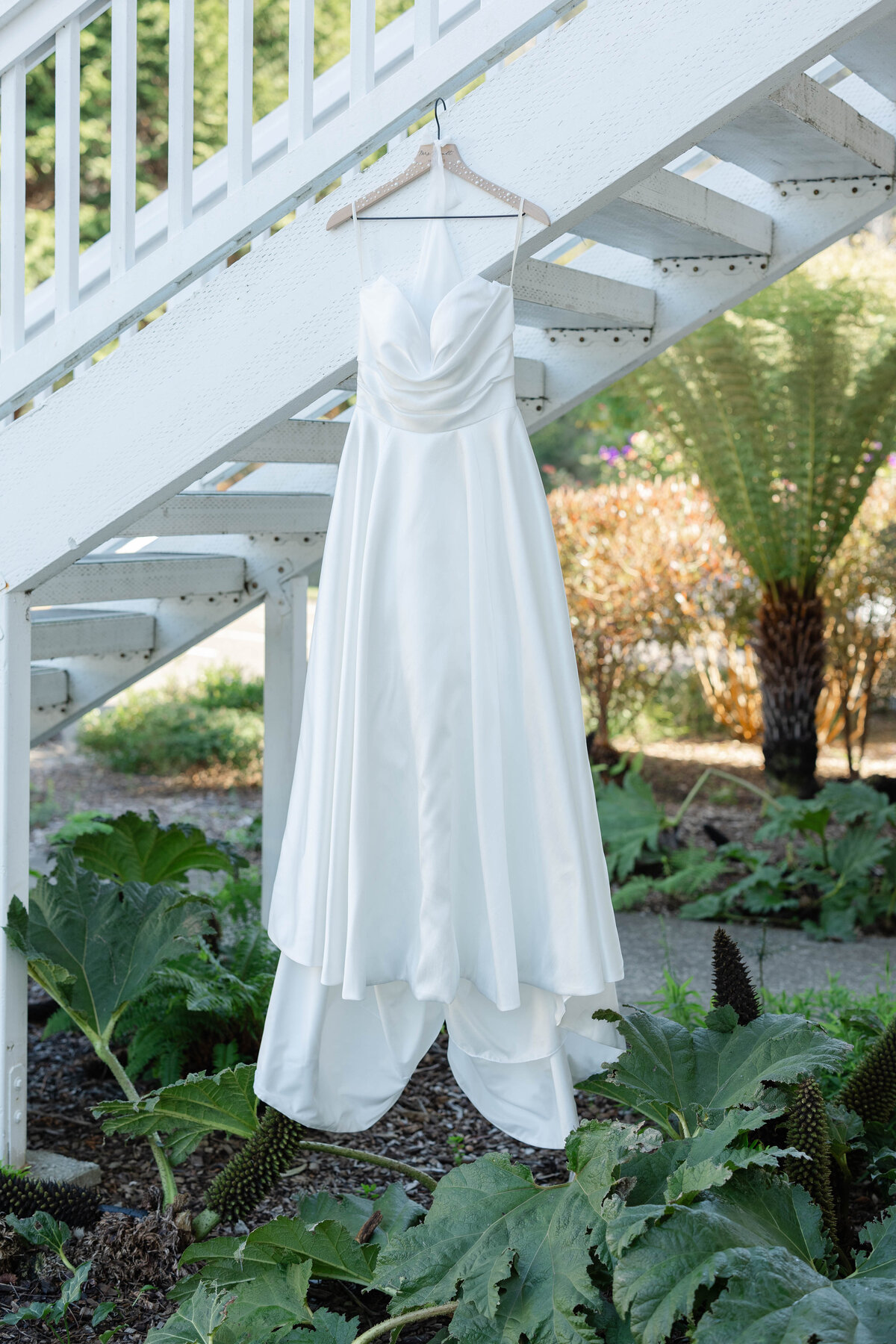 Wedding dress hanging in front of brides room