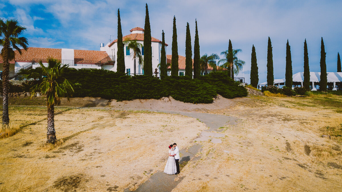 An aerial drone picture of a bride and groom sharing a moment overlooking the southridge estates in yuba city california