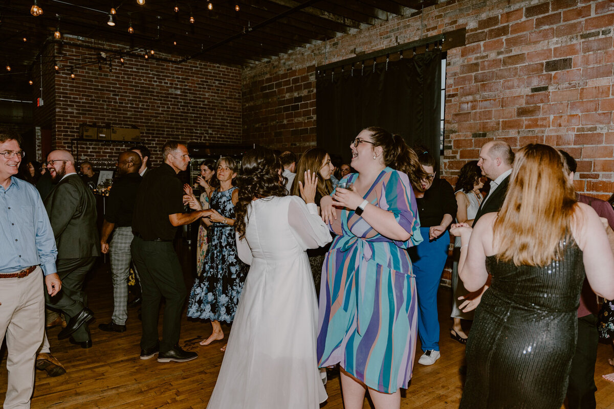 wedding-reception-bride-dancing-with-guests-noce-des-moines-wedding-photographer-storyteller-collective-photo-co
