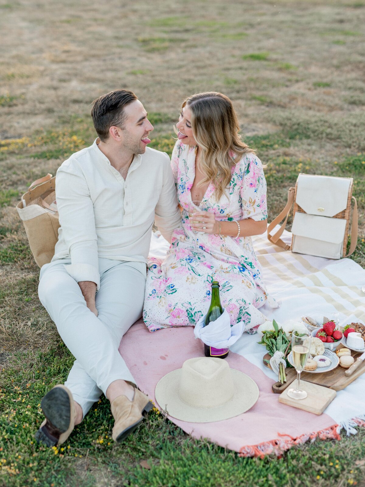 Fun and flirty picnic engagement in San Luis Obispo—champagne, laughter, and love at golden hour.
