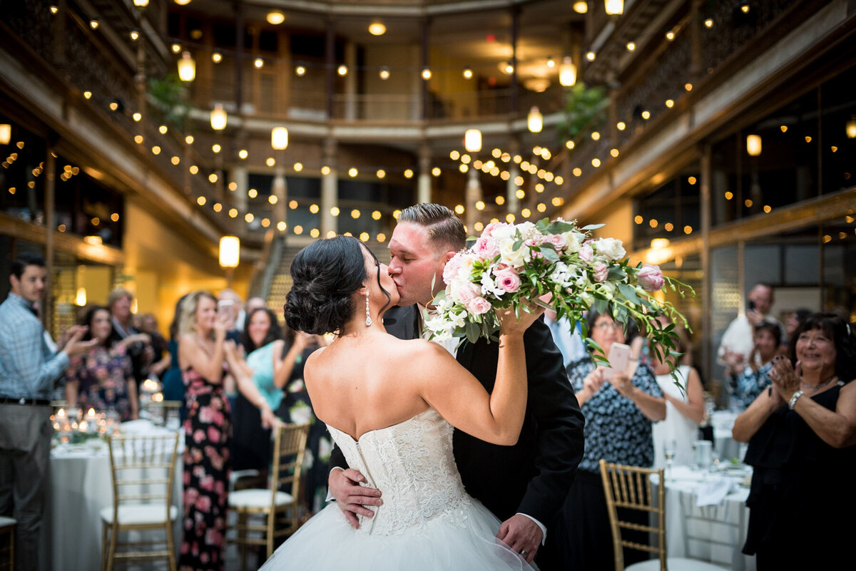 Couple kisses during first dance at Clveland Arcade