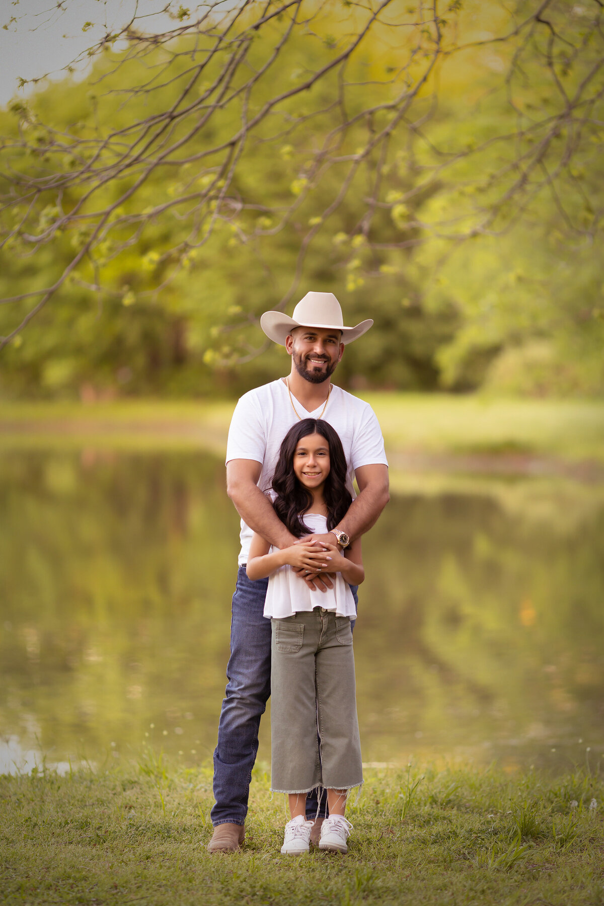A sweet moment captured by a Dallas family photographer, a father and daughter standing together by the water in Dallas.
