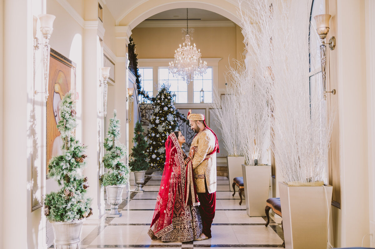 Indian bride and groom share a moment in the hallway at the aria banquet in connecticut