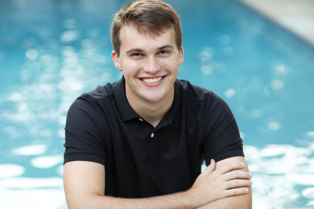 Senior boy in front of pool, outdoor photoshoot