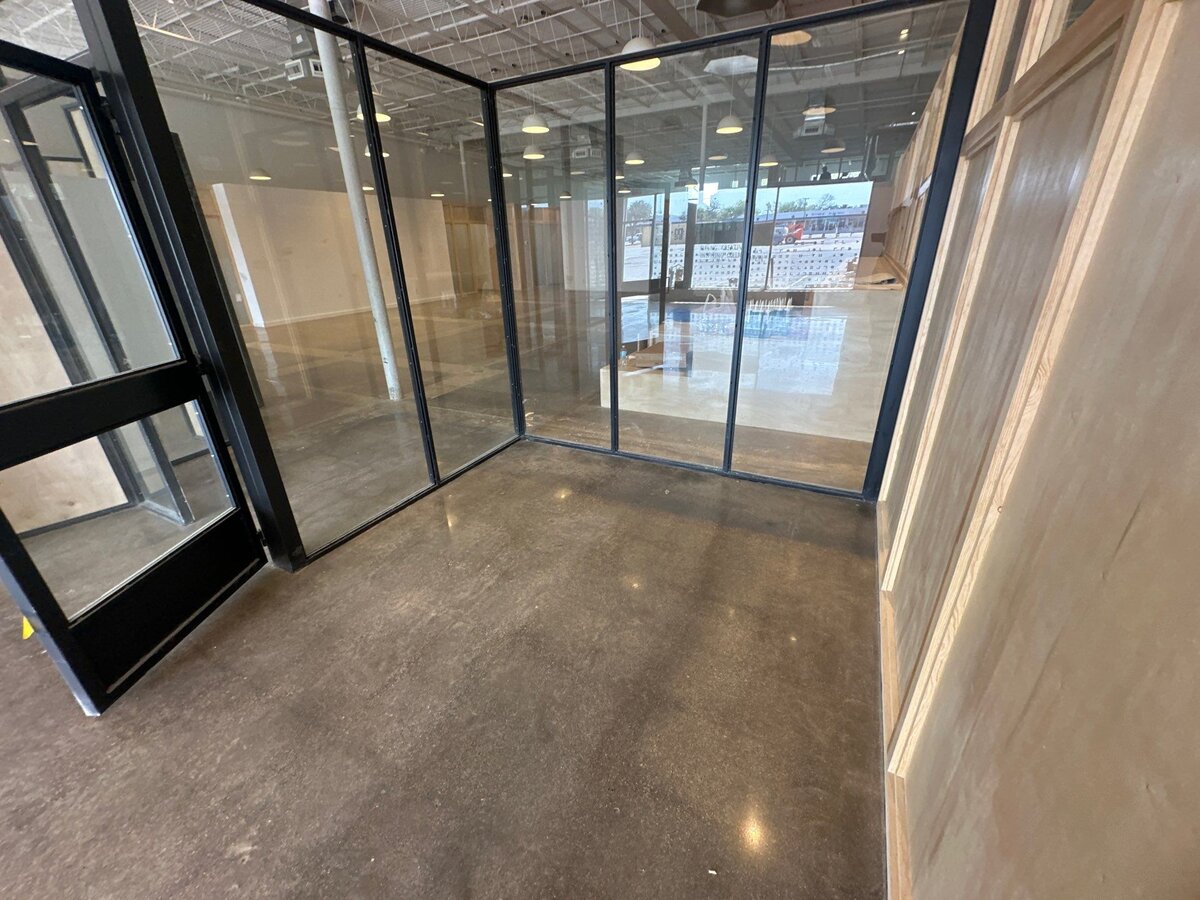 Polished concrete flooring for businesses, featuring a smooth, shiny finish ideal for commercial spaces with durability and easy maintenance.