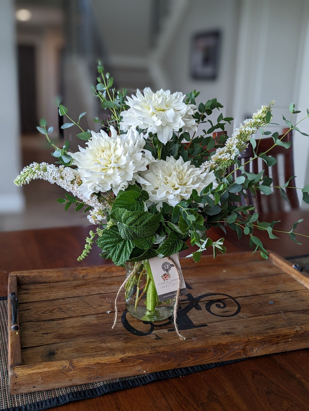 white funeral flower arrangement in vase