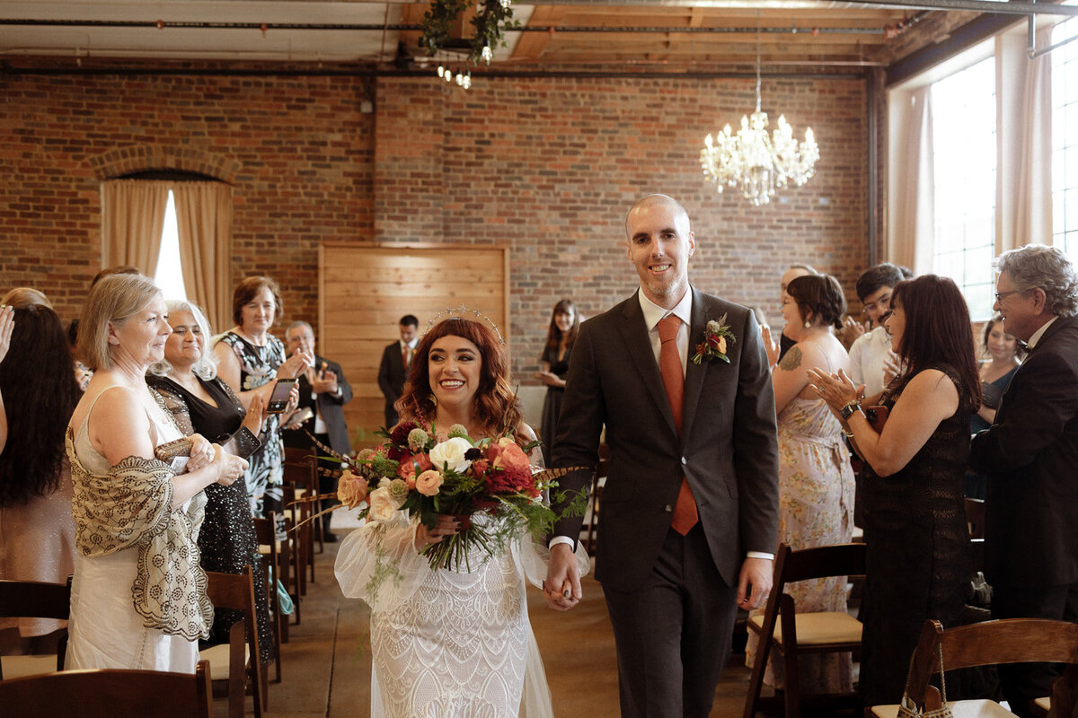 Bride and groom as they exit the aisle after their wedding ceremony.