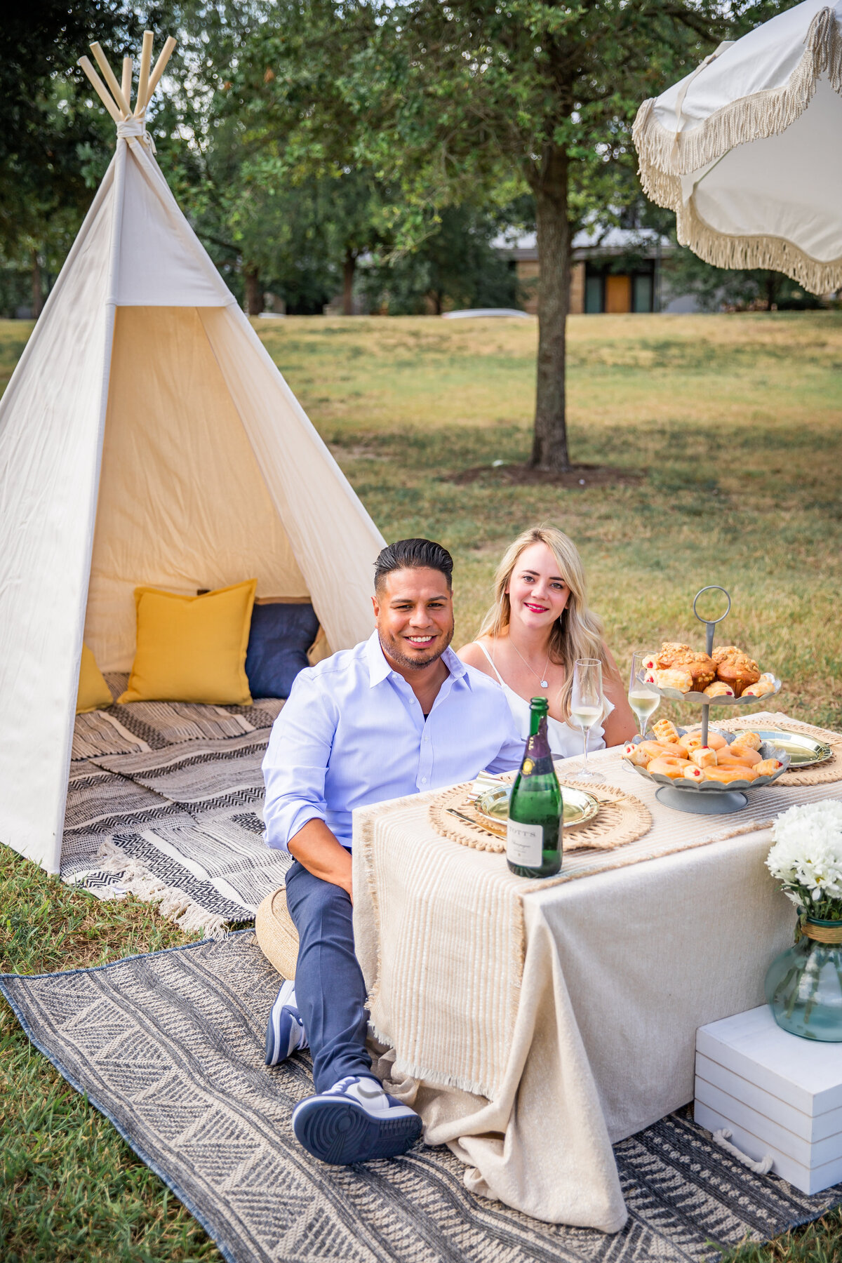 Proposal ideas outdoor picnic couple smiling at camera