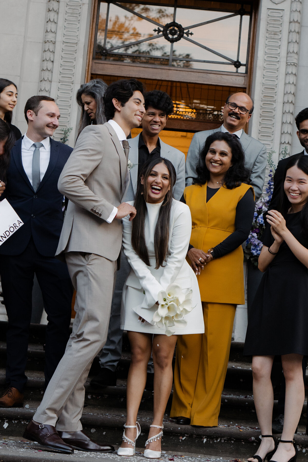 fun group photo of bride and groom with full wedding party