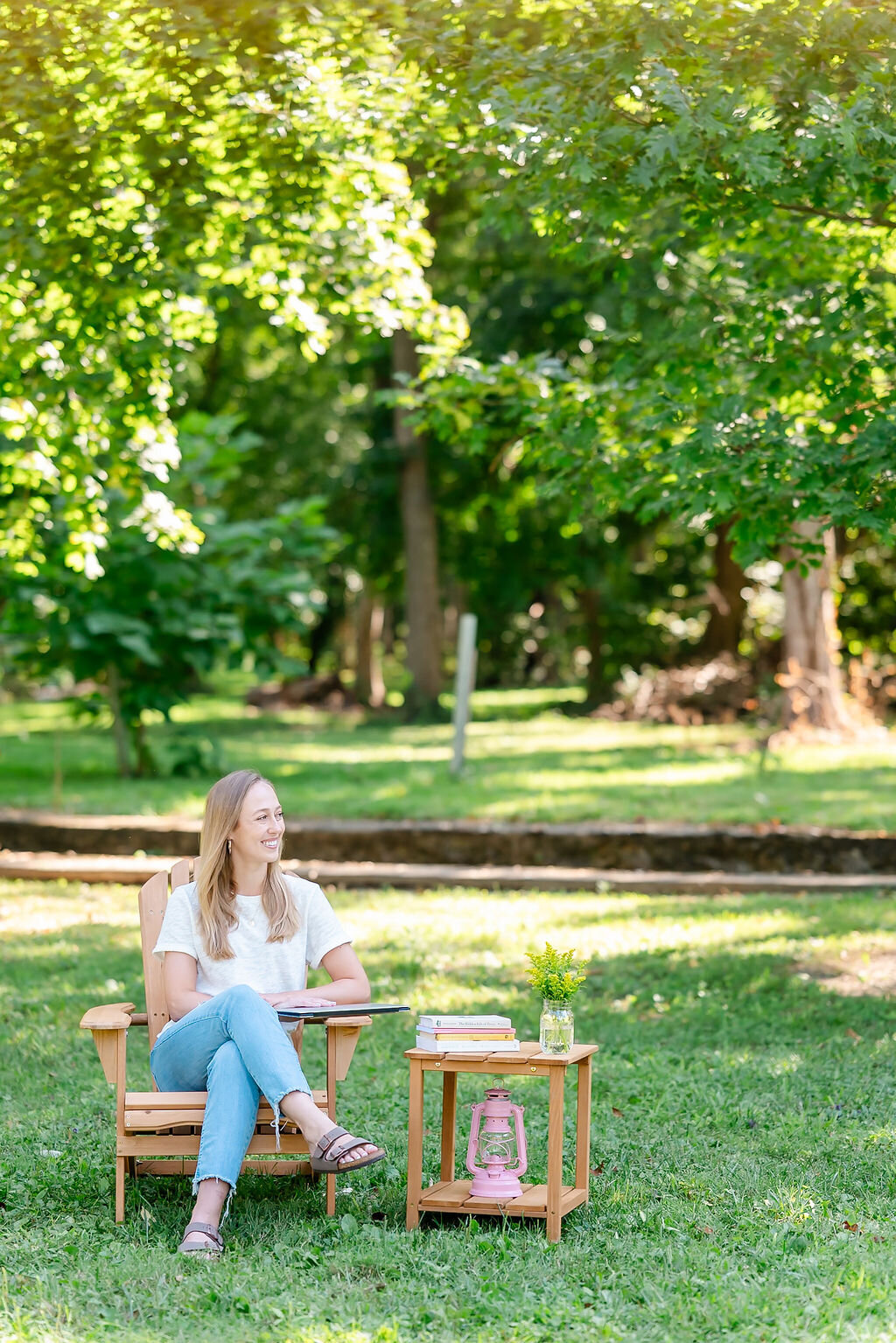 Virtual assistant Emily Howell sitting on a chair in a park smiling