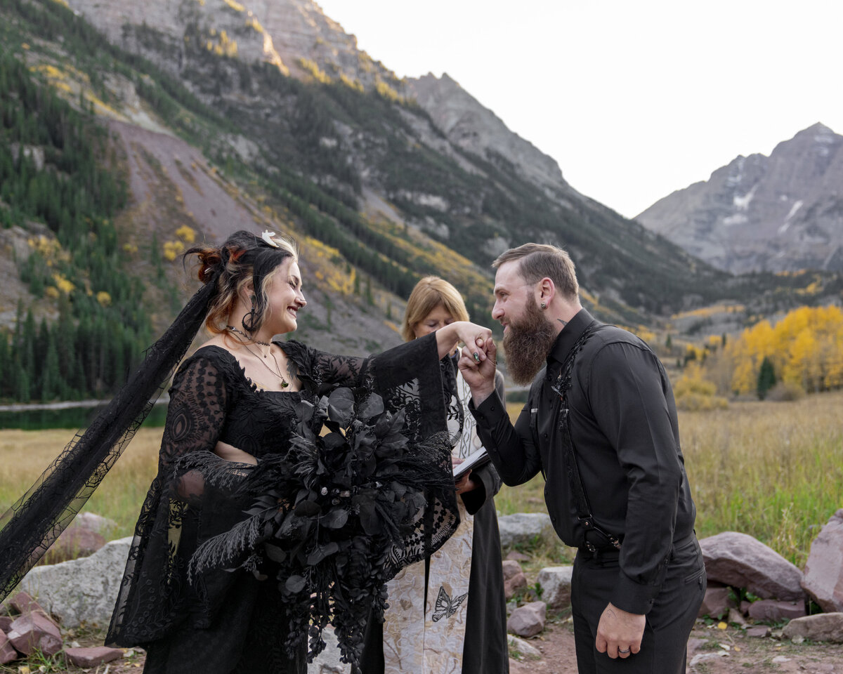 man kissing bride's hand