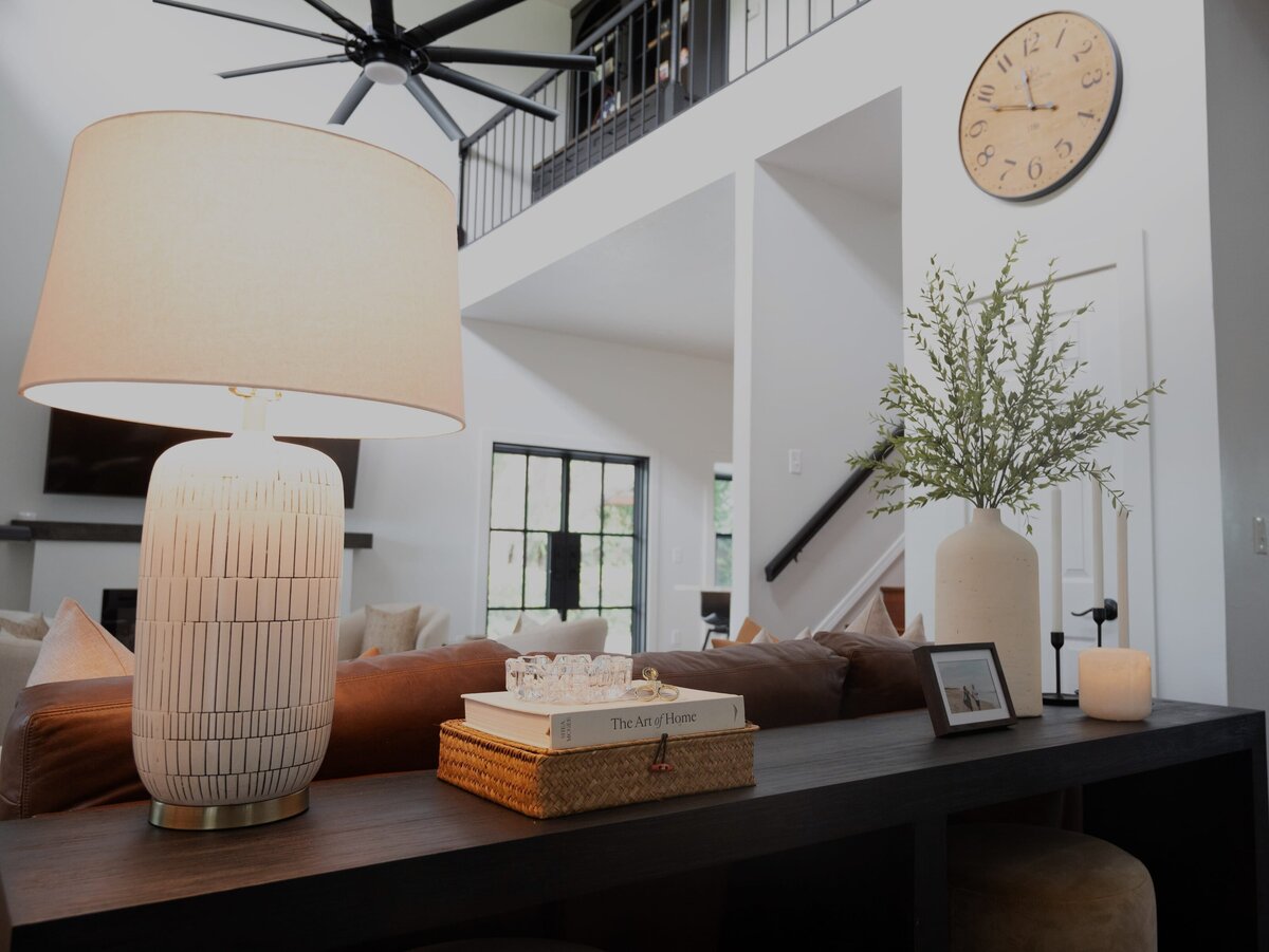 dewine design orlando interior design farmhouse modern living room with white lampshade on wooden table