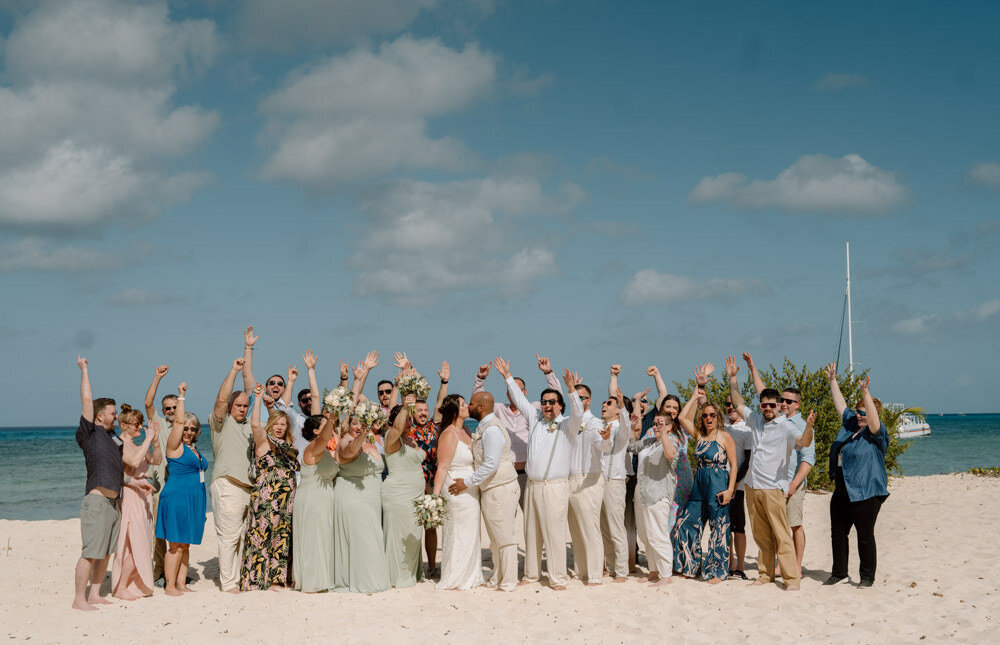 a group of cheering guests at a wedding in Cozumel