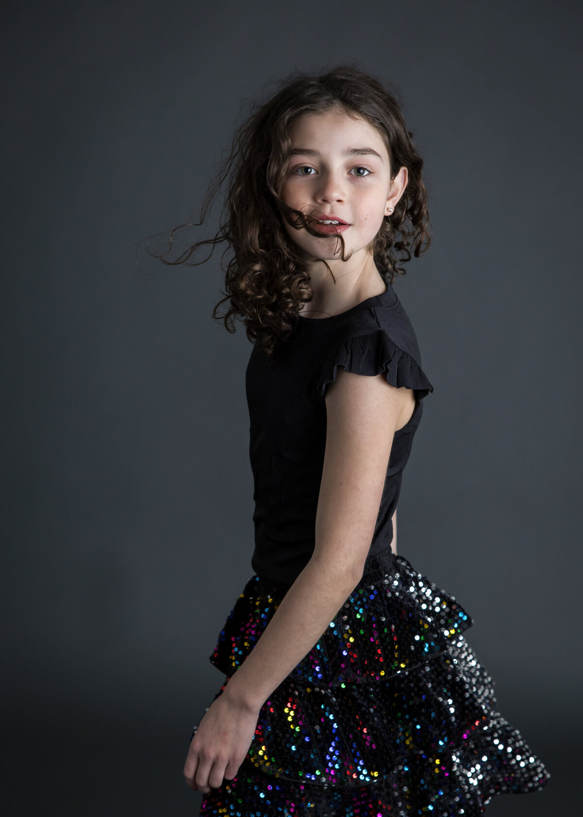Dark and moody photo of a girl dancing at Allison Reilly's Union County, NJ photo studio.
