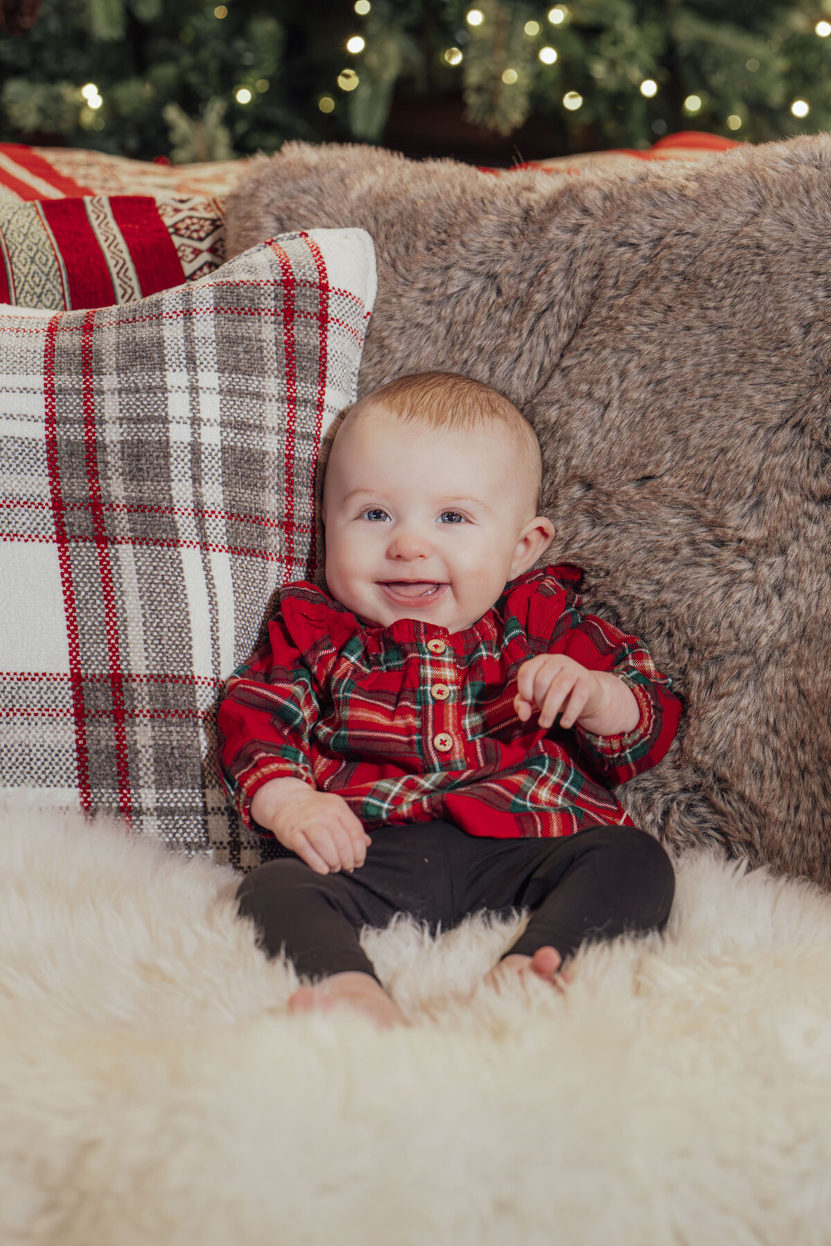 Family Photographer | Baby and family posing together during cozy indoor Christmas portrait session | New Jersey