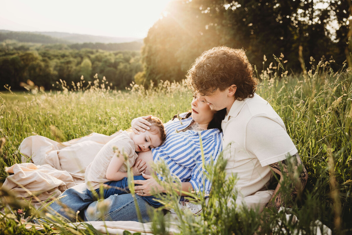 family snuggling in portrait session with reva davis photography