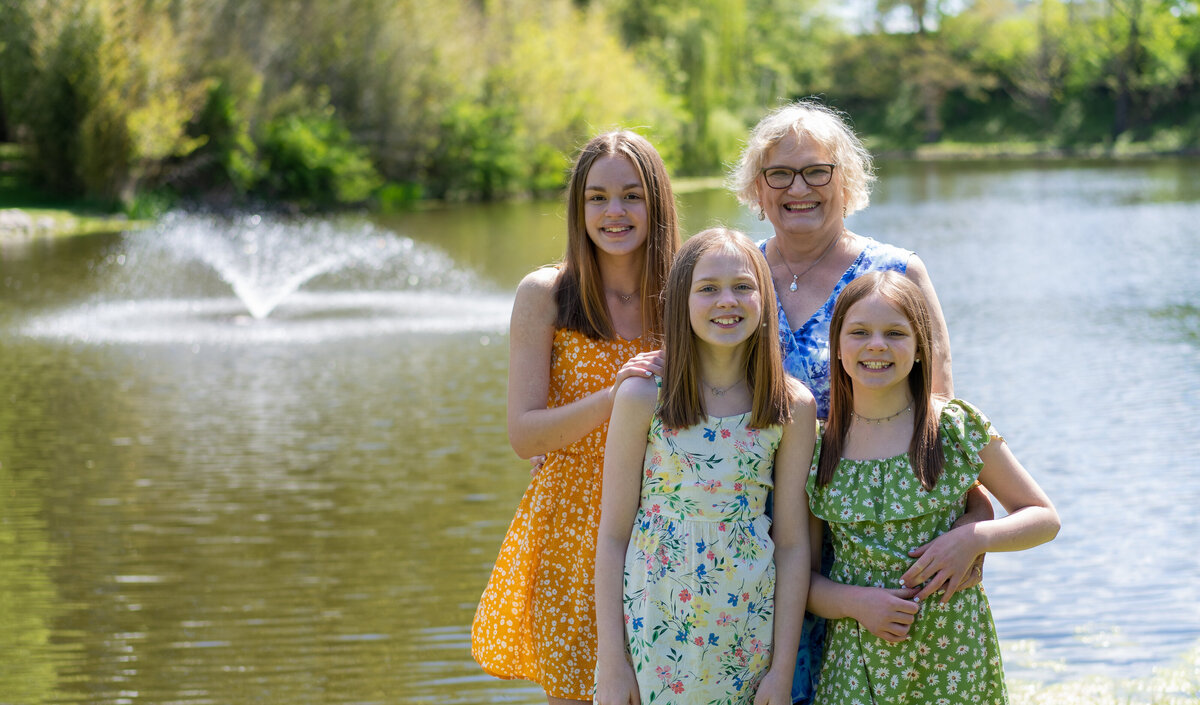 Peg Gries and her three granddaughters pose together in front of a fountain at Schedel Gardens in Elmore, Ohio.