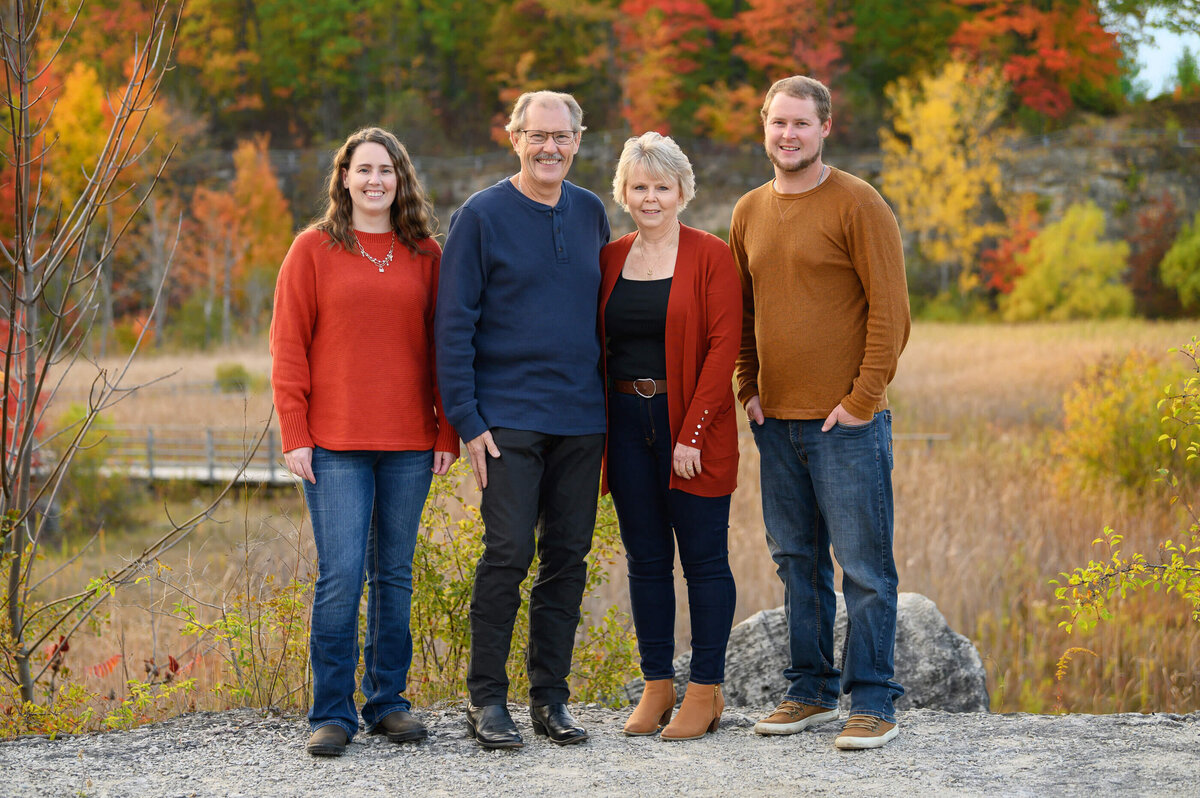 Mom and dad with their adult son and daughter for their extended family fall photos in Burlington, ON