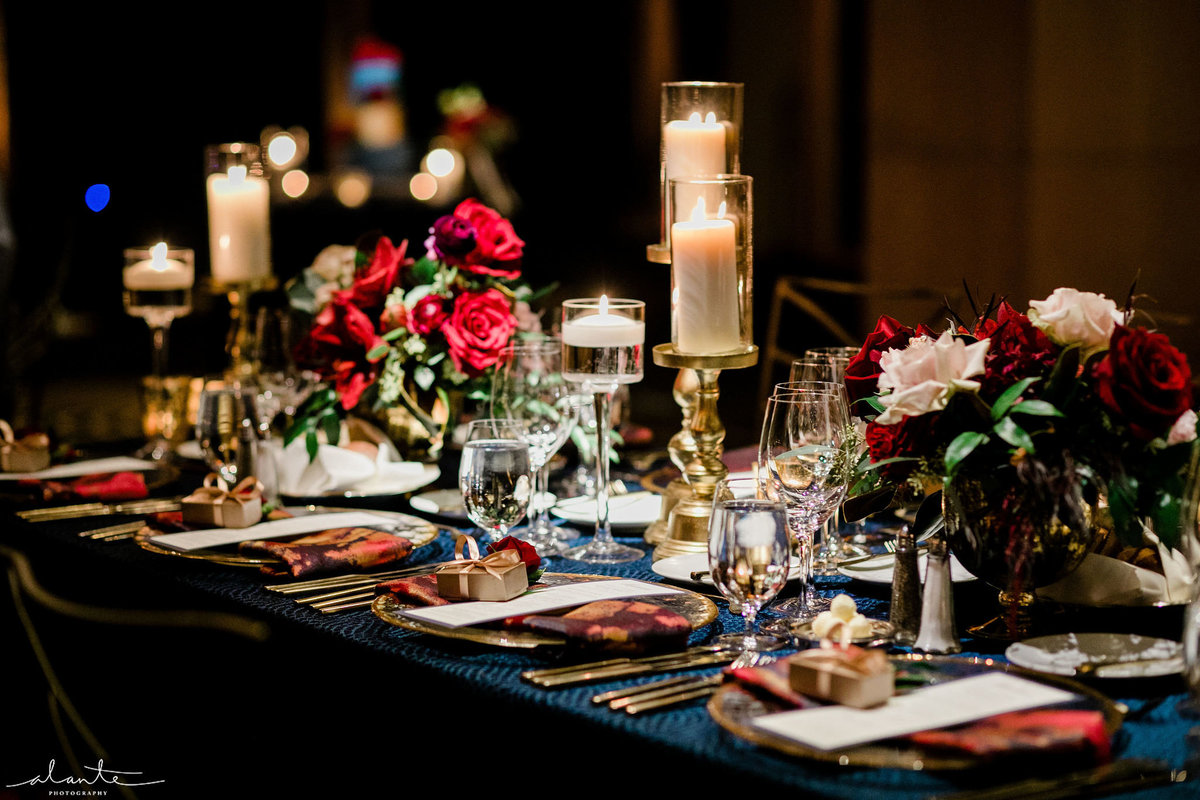 table scape of candles and red flowers for a winterb wedding
