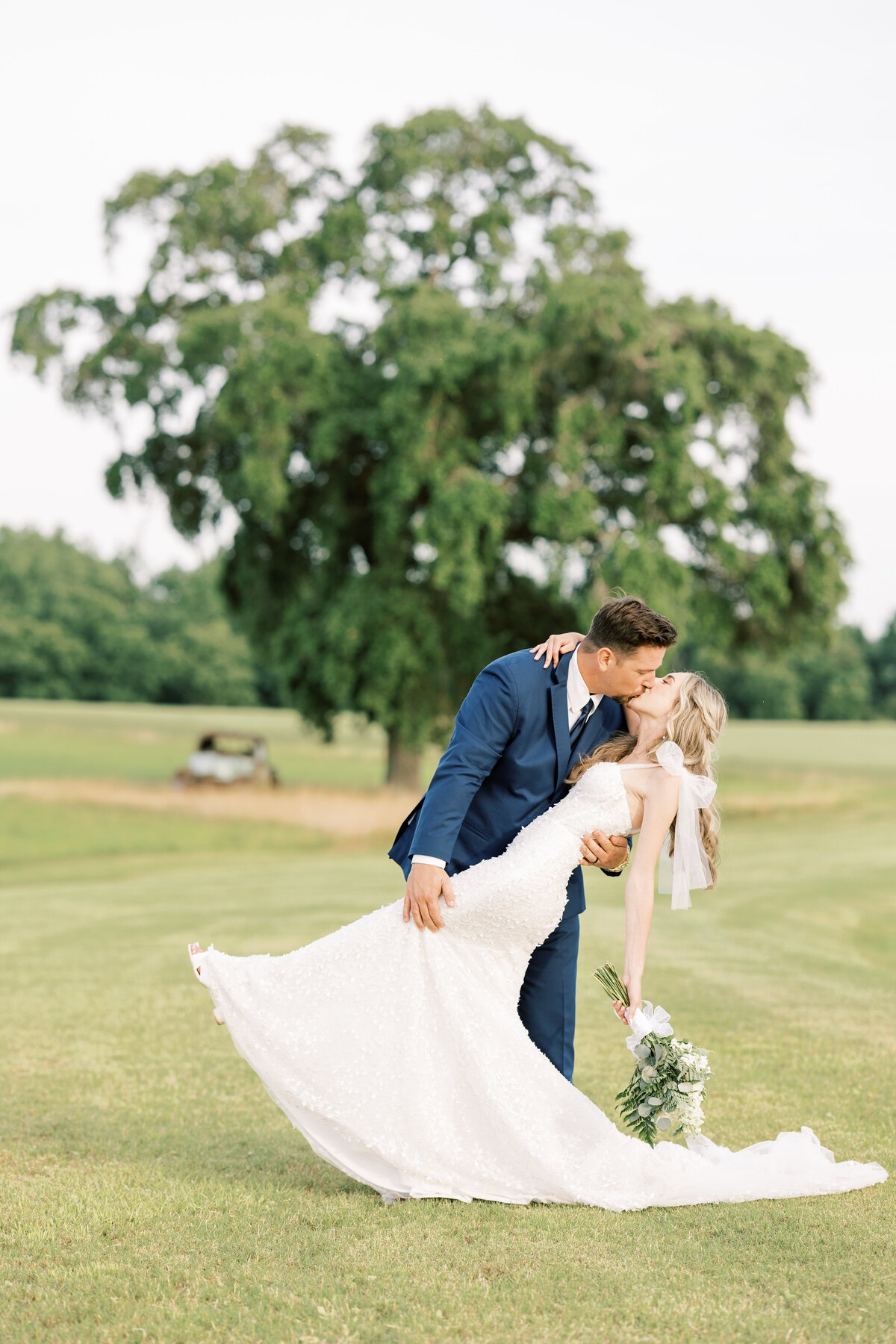 groom dipping and kissing his bride on their wedding day