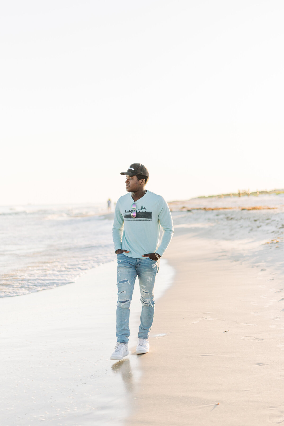 senior guy walking on the beach