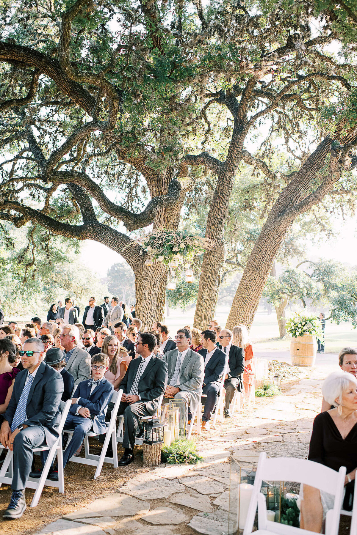 Beautiful outdoor wedding underneath large oak tree in the Texas Hill Country