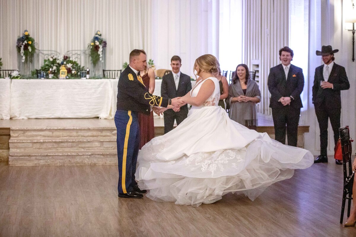 bride's ballgown spins during father daughter dance at Military wedding