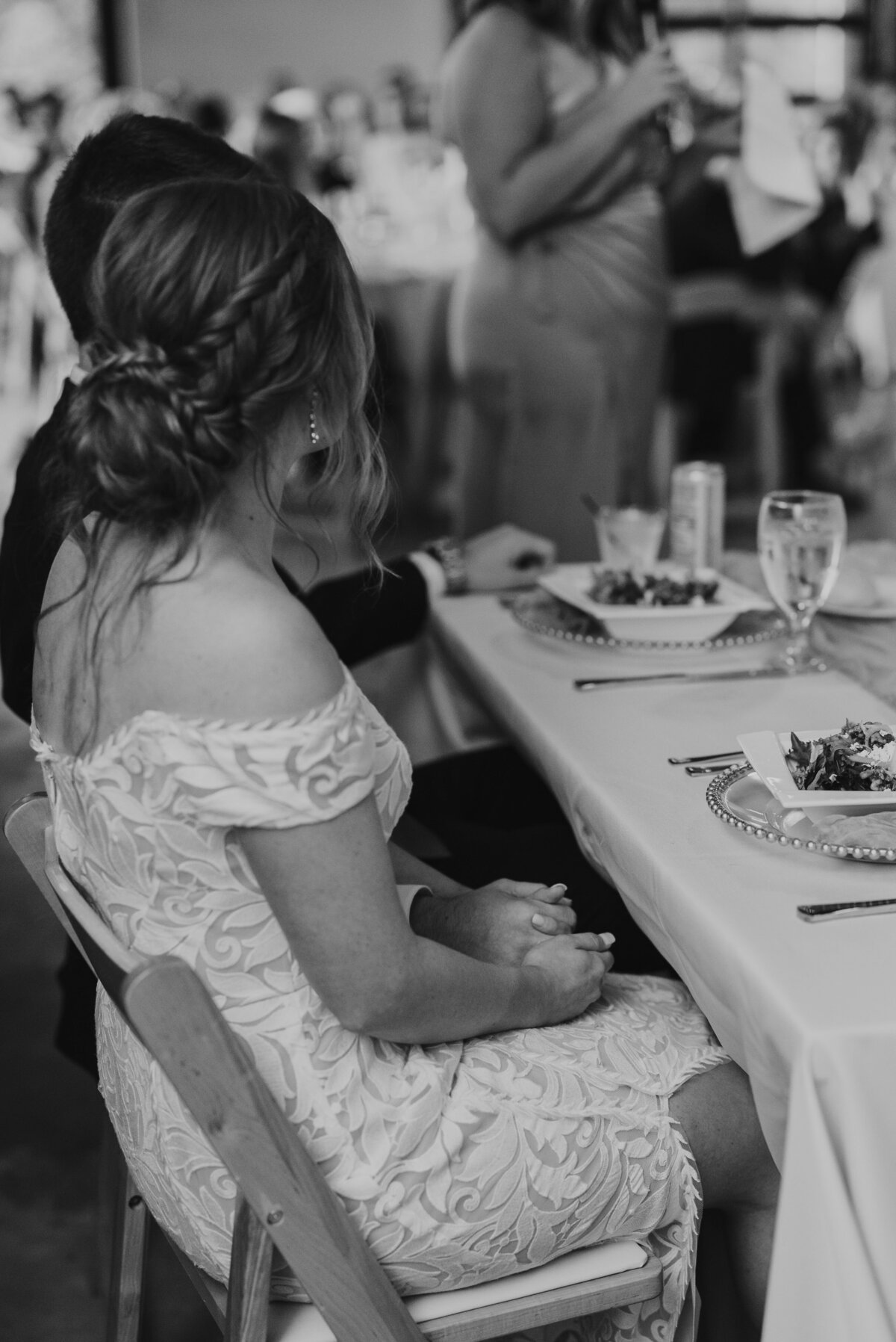 couple holding hands at a reception