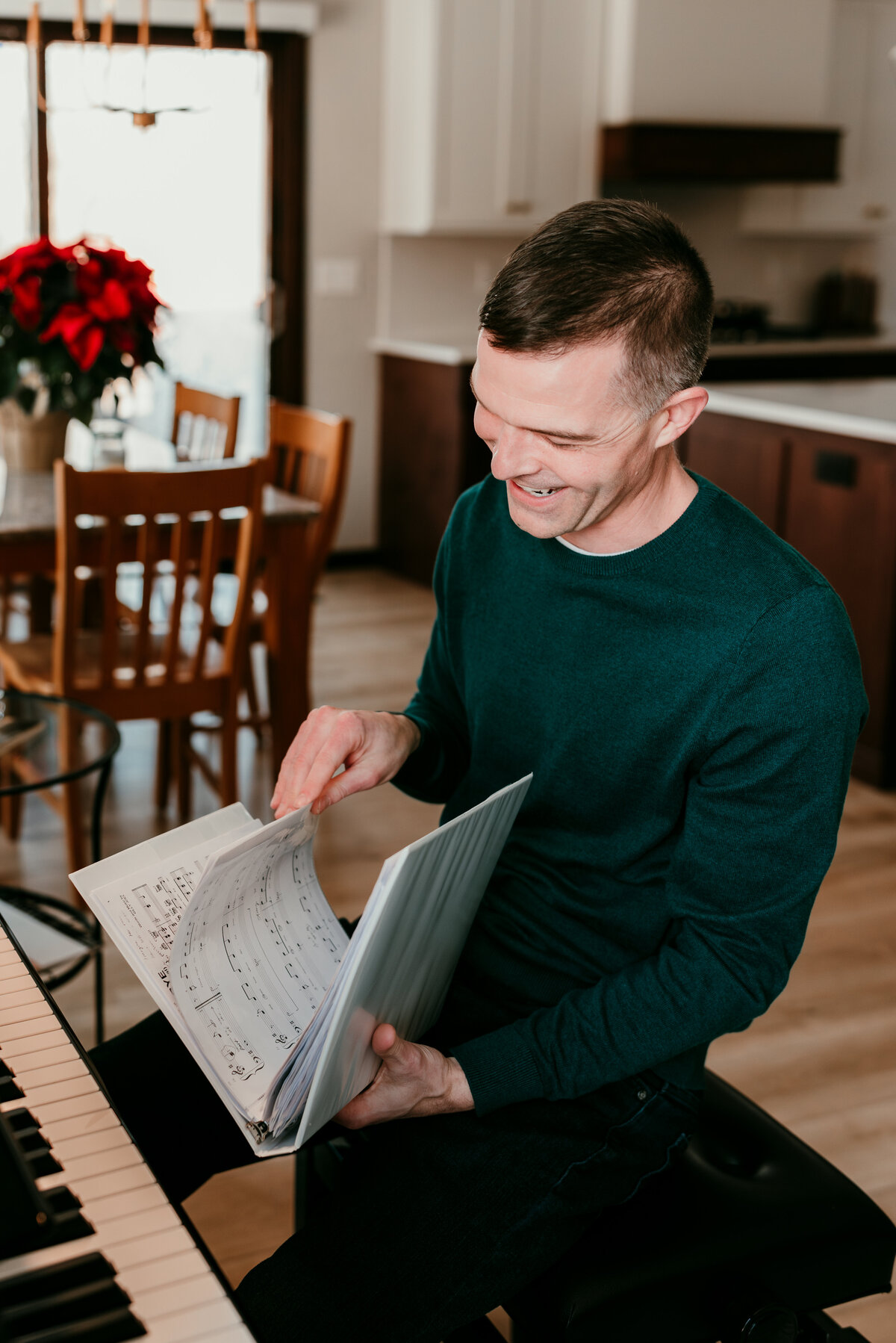 Man seated on a bench at his piano , offering a cozy and intellectual look for his dating profile.