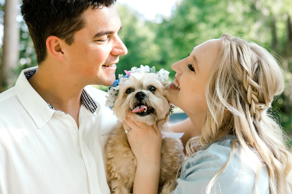 couple snuggling dog