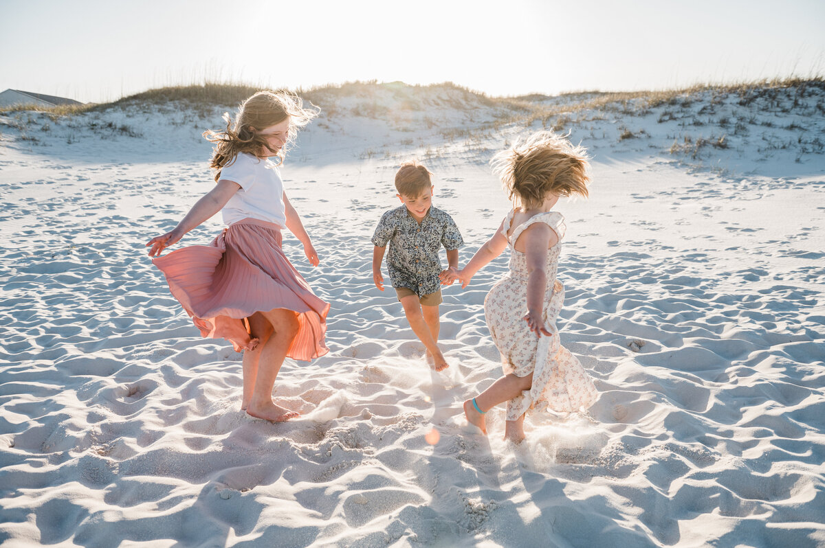 kids twirling in dunes at Perdido Key Beach