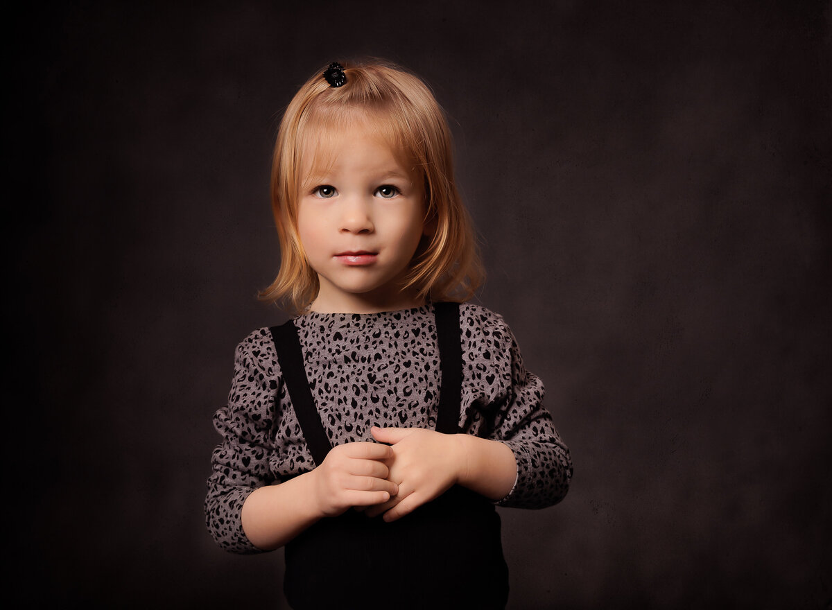 Little girl is captured with an intent glare for a studio portrait in brooklyn, ny. Captured by Brooklyn family photographer Chaya Bornstein