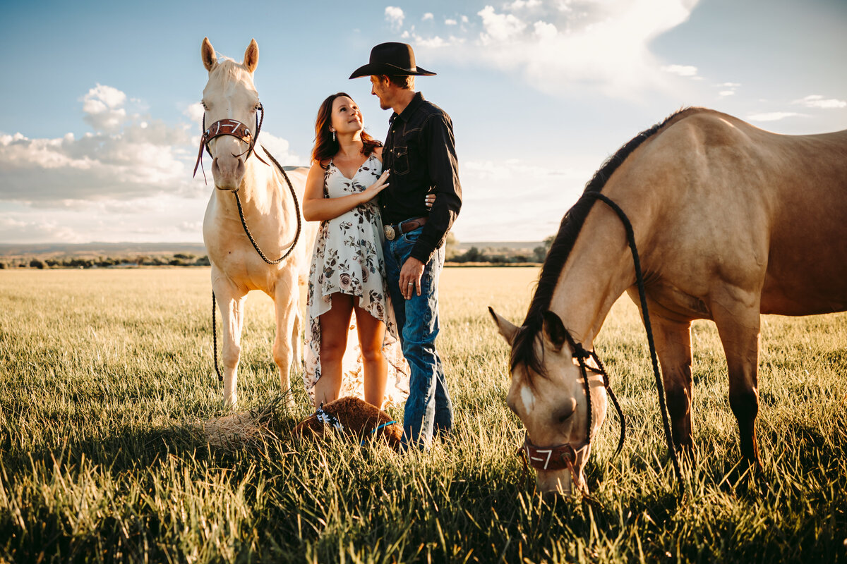 Couple poses with their horses for their Telluride maternity session.