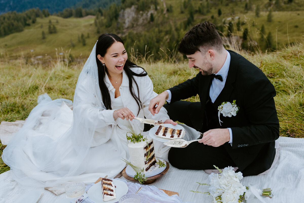 Picnic setup with wedding cake and plates in the Dolomites.