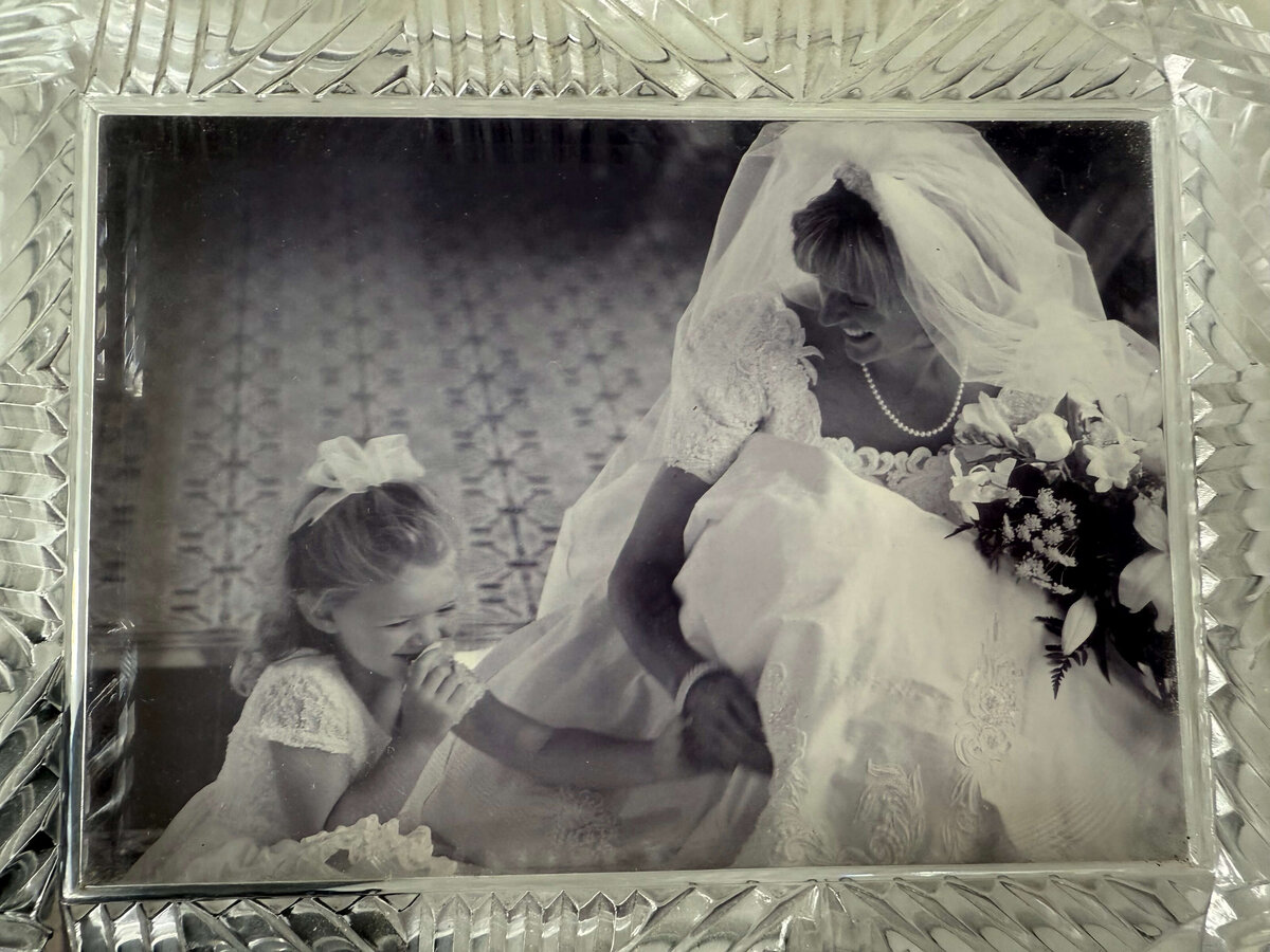 first photo Michaela Joy photographed at 14 year old representing a little flower girl and the bride laughing