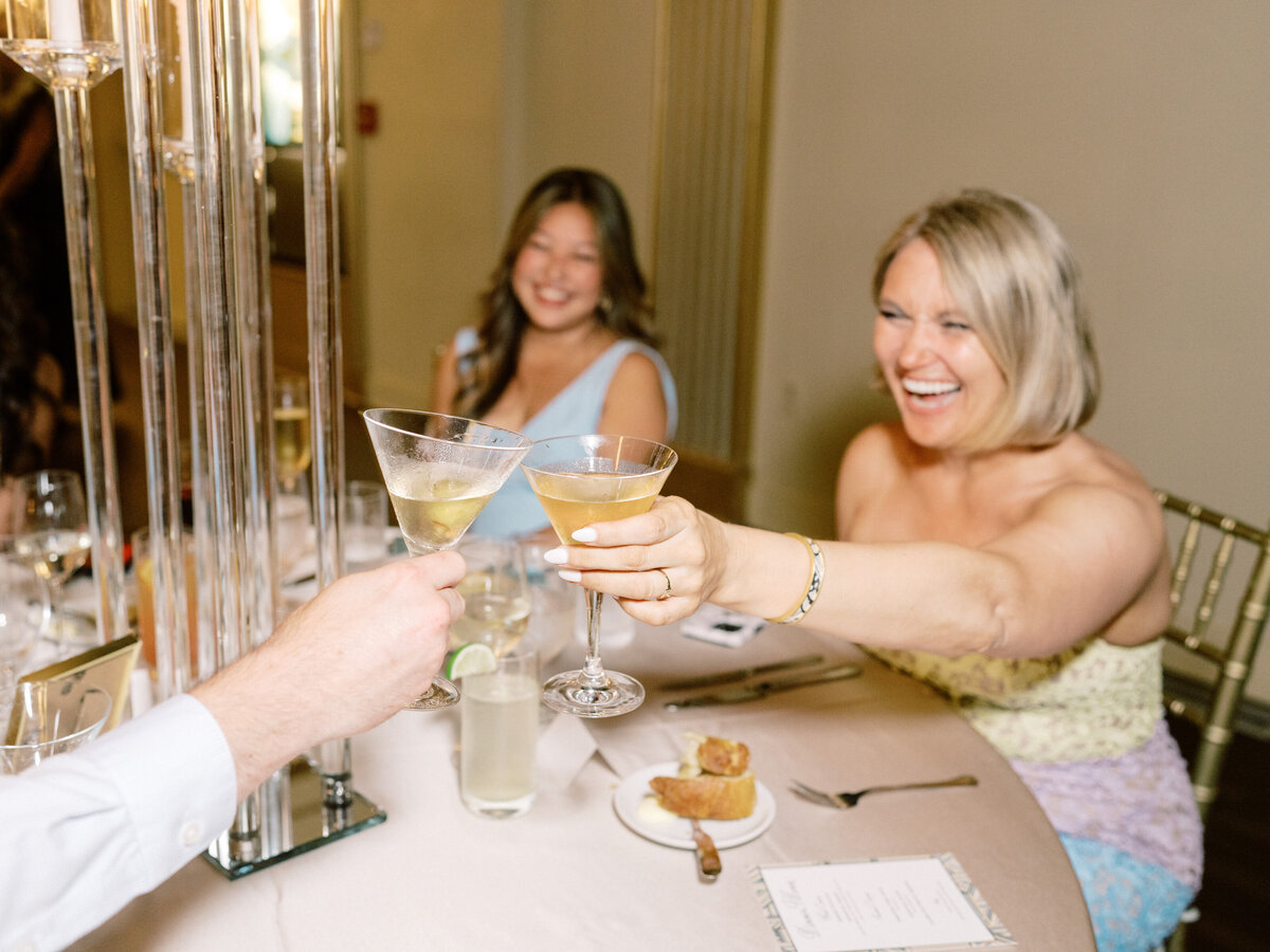 A joyful gathering captured as friends raise their cocktails, showcasing the essence of celebration, friendship, and memorable moments shared at a wedding.
