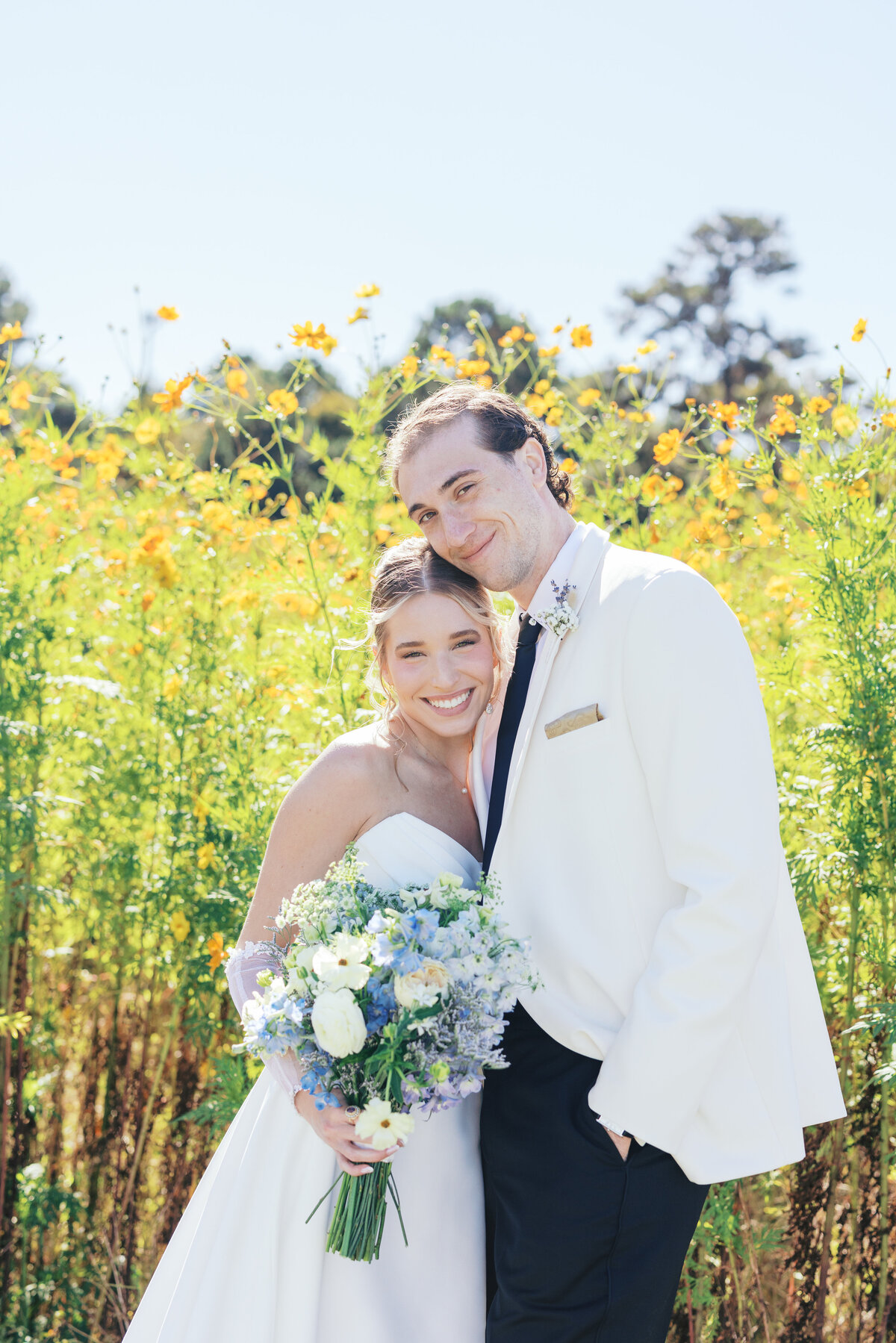 Bride and groom smile at the camera in Charleston