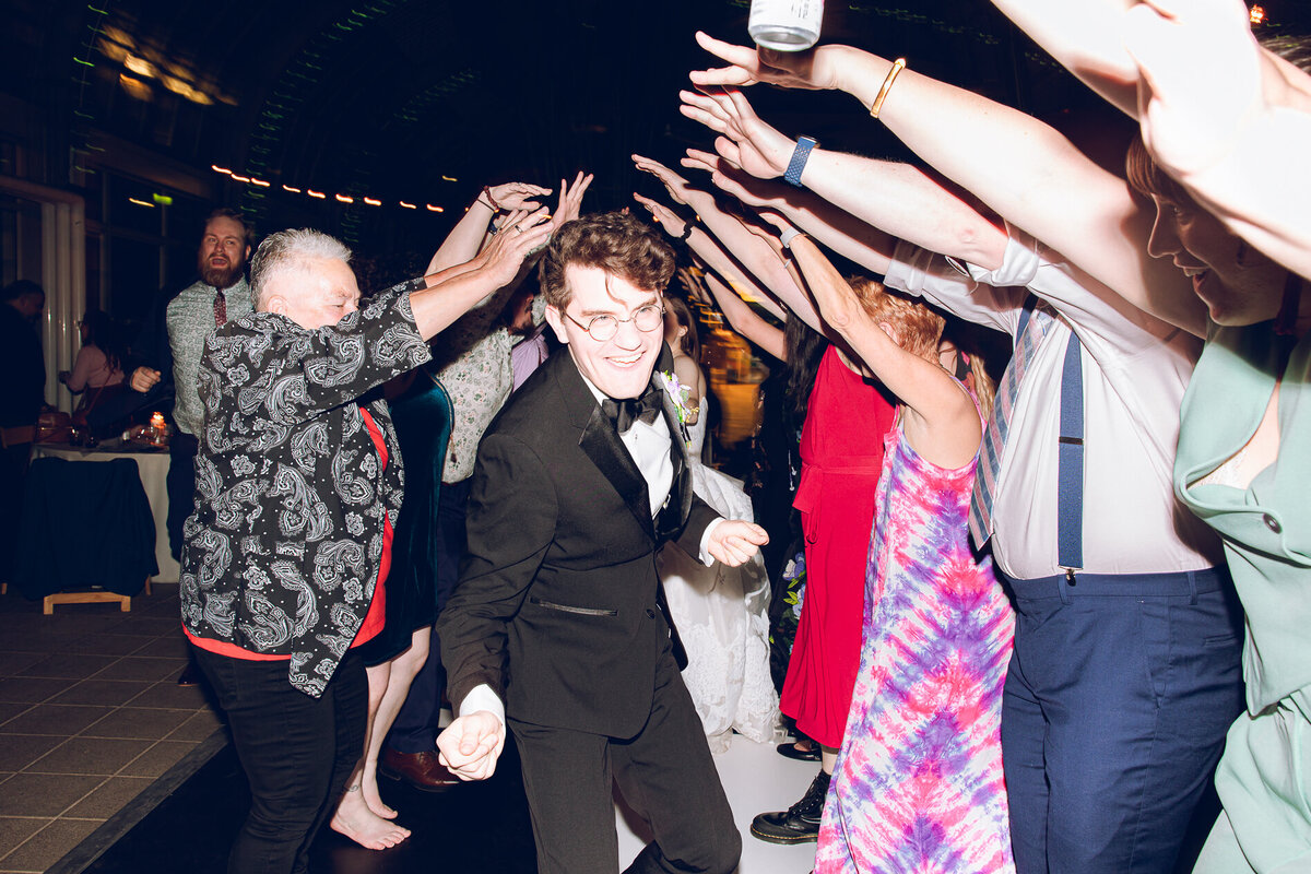 A couple shares a dance with their guests during their reception at the Garfield Park Conservatory in Chicago