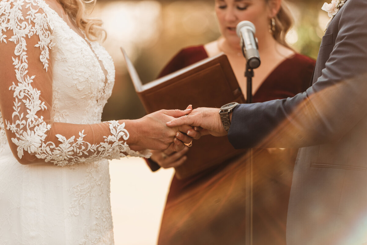 Close-up detail of bride and groom being wed with officiant during their wedding ceremony in Pennsylvania