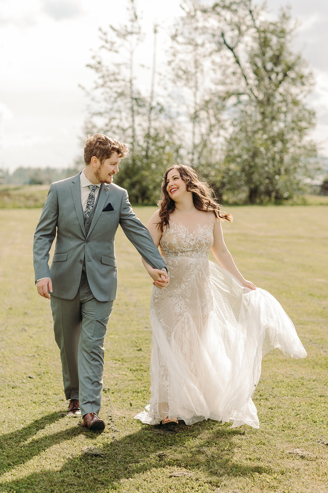 Utah Wedding Photography capturing bride and groom walking together after spring wedding