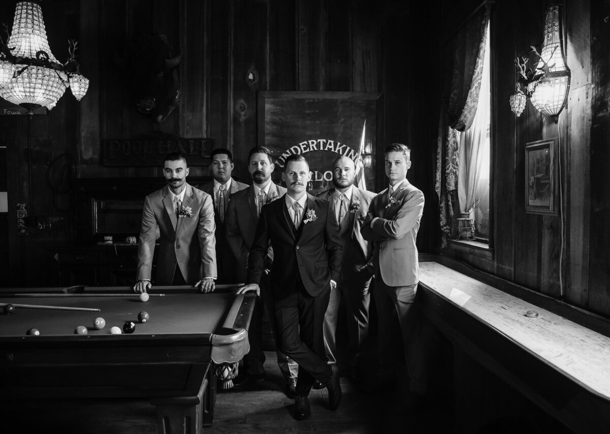 groomsmen standing by pool table