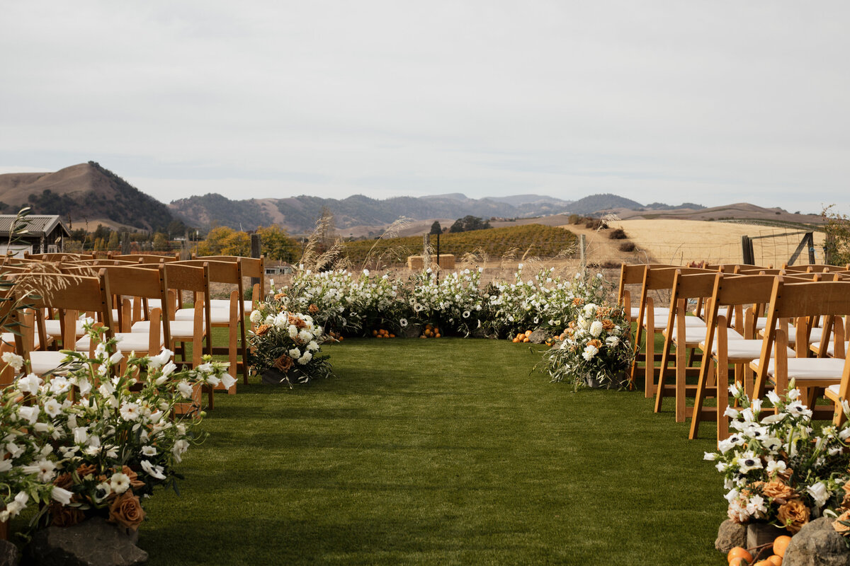 A timeless wedding reception scene at Carneros Resort in Napa Valley, featuring a romantic vineyard backdrop and glowing string lights.