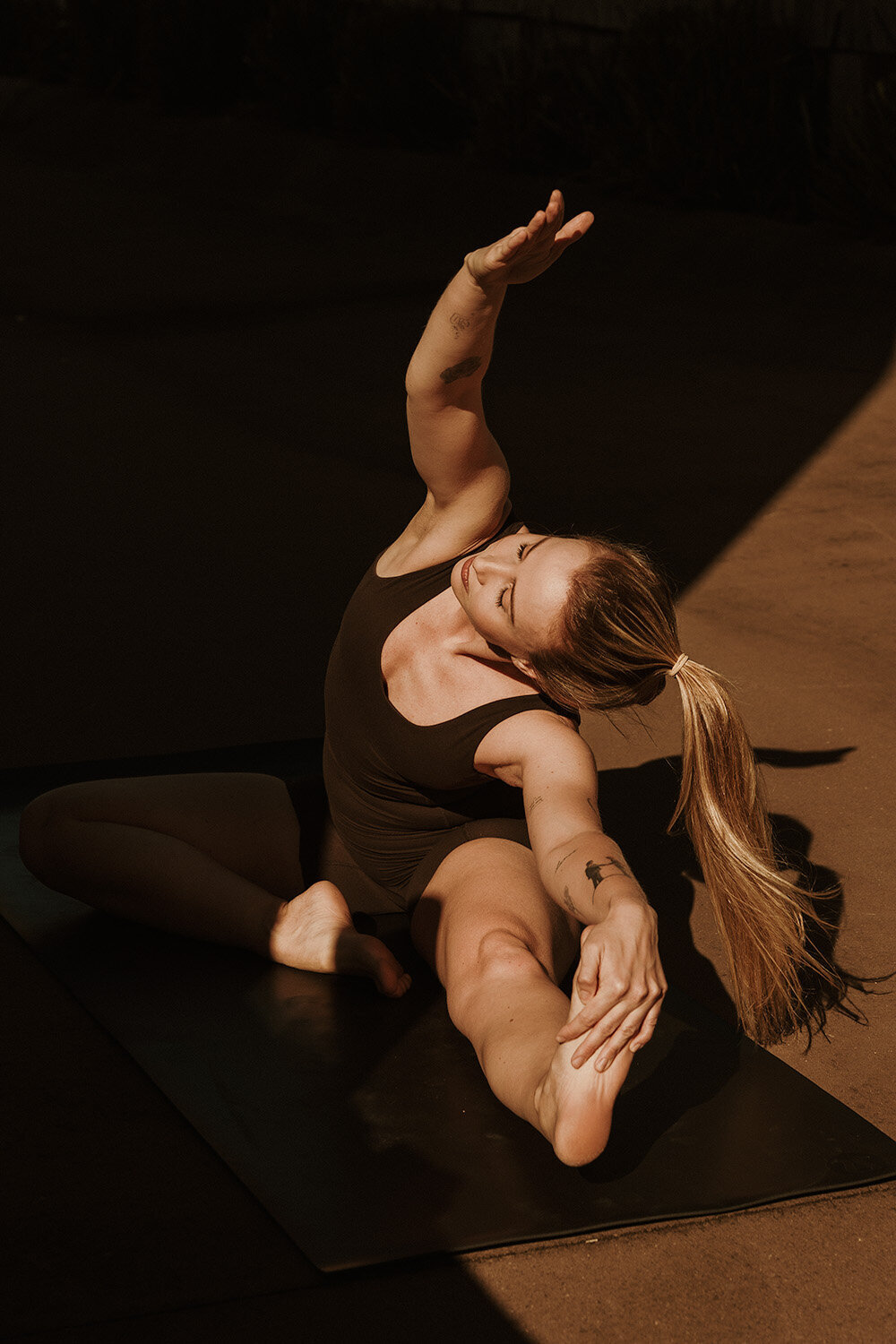 Sunshine Coast branding photographer captures a powerful stretch pose for a fitness-focused brand session.
