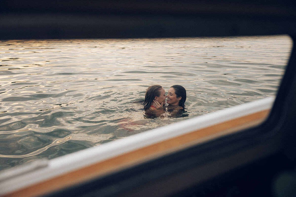 Couple is seen swimming together through window of sailboat aboard The Whippoorwill boat in Nashville, TN. 