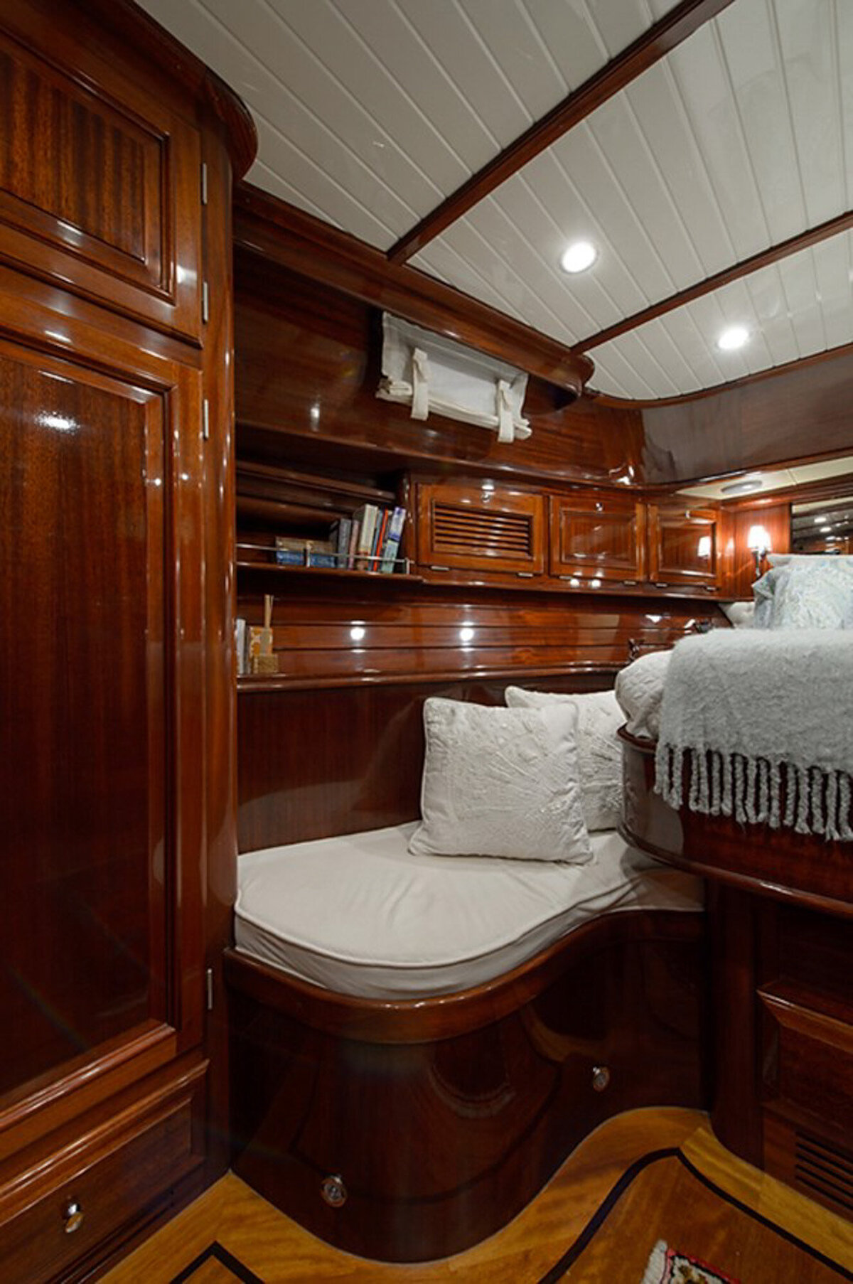 elegant room on a boat featuring polished wooden walls and ceilings