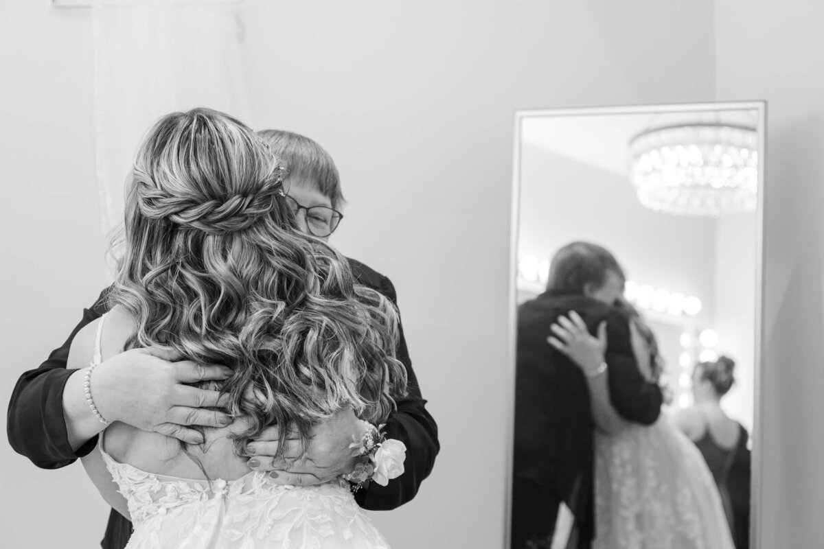 Timeless wedding photo of a bride hugging her grandmother at The Eloise near Madison, WI