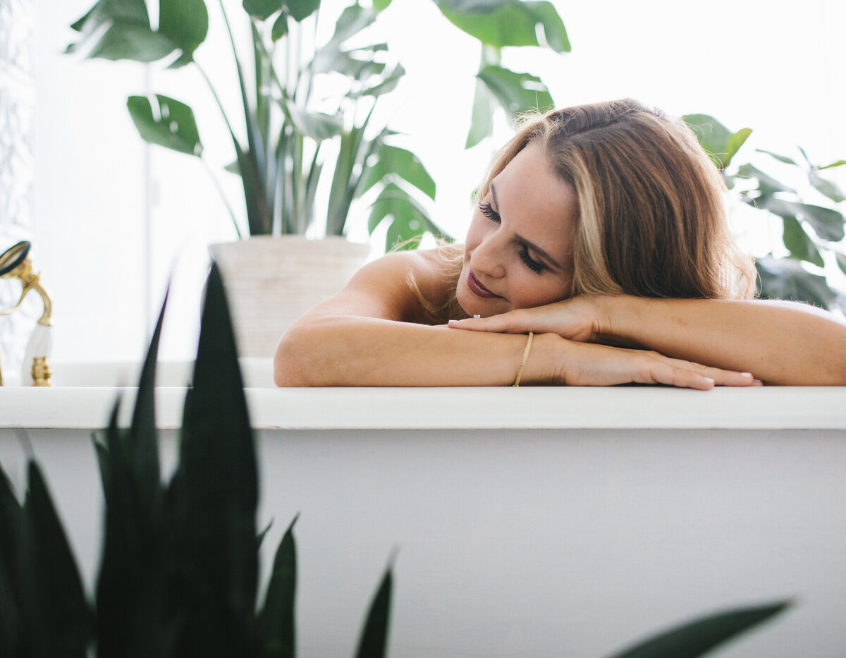 Portrait of woman posing on the edge of bathtub